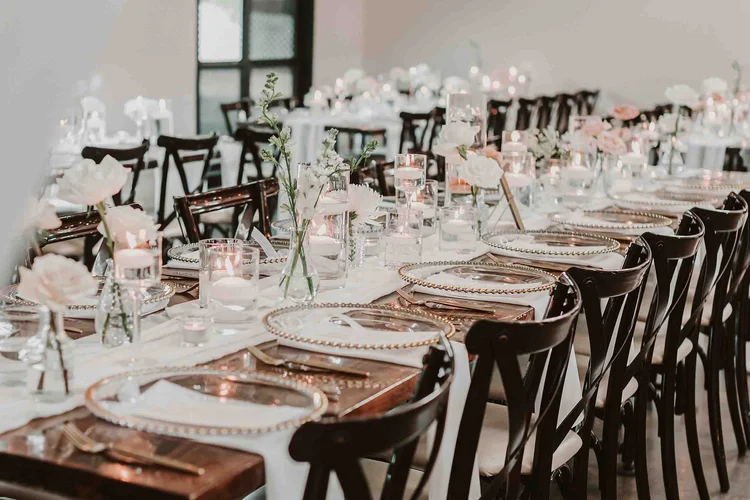 wedding reception table with charger plates and floating candles